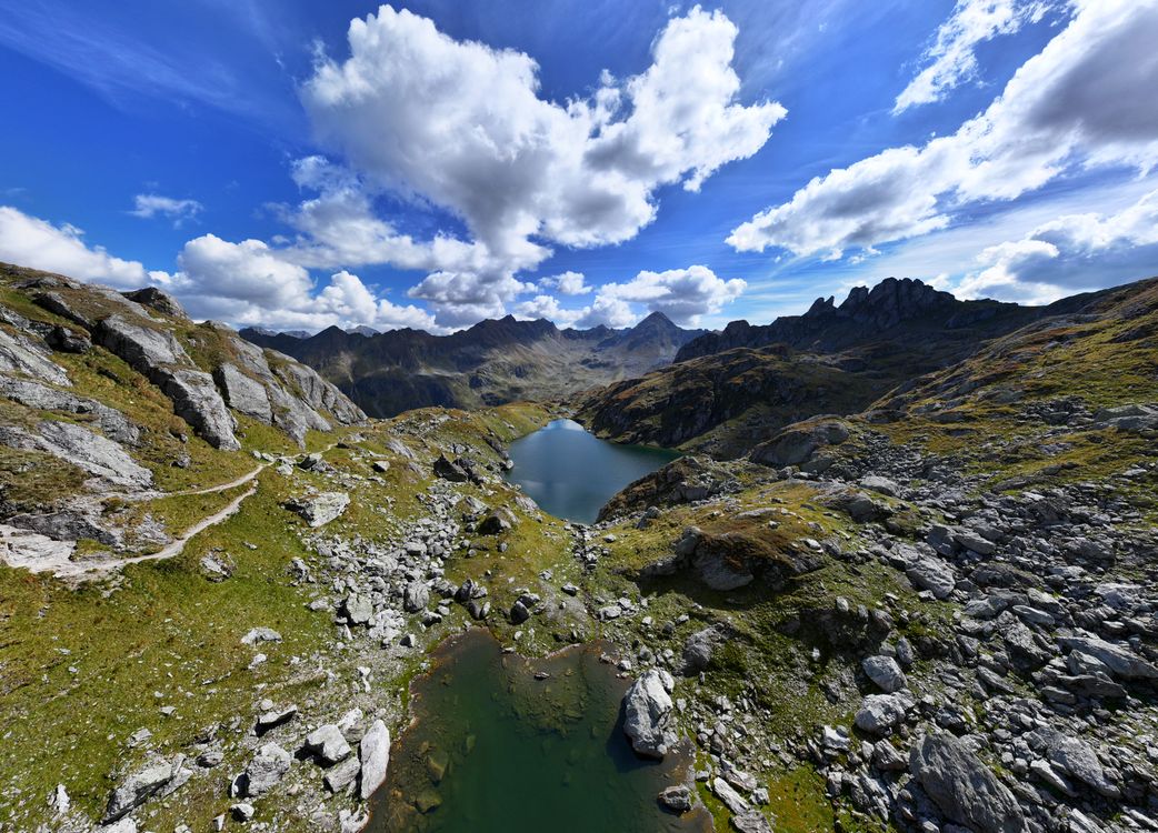 A mountain lake beneath a dramatic blue sky